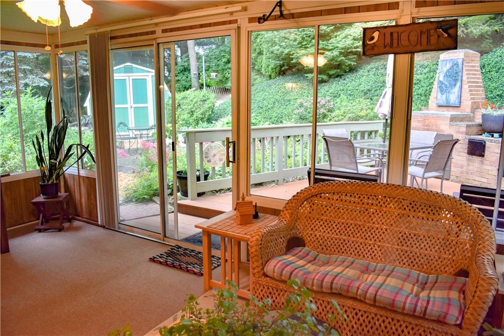 113 Morningside Drive Butler, PA 16002 - Photo 10 of 25 The sun room exits to the rear deck, fireplace, custom patio and charming walkways to enjoy the manicured rear yard. A nice shed is also included!