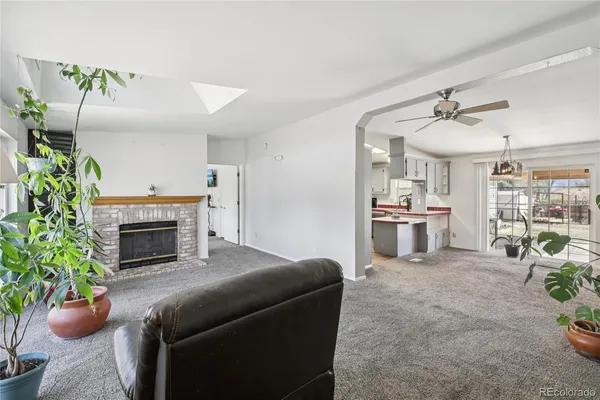 a living room with furniture potted plant and a fireplace