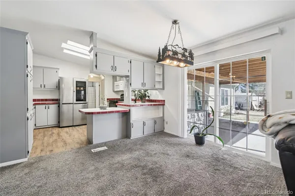 a kitchen with stainless steel appliances a sink stove refrigerator and cabinets