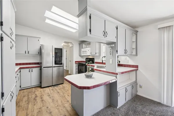 a kitchen with a sink stove and cabinets
