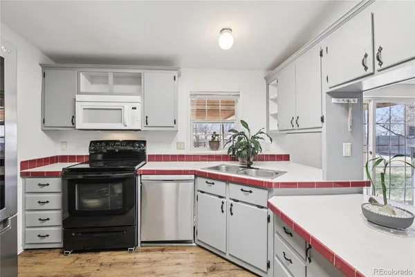 a kitchen that has a sink and a stove