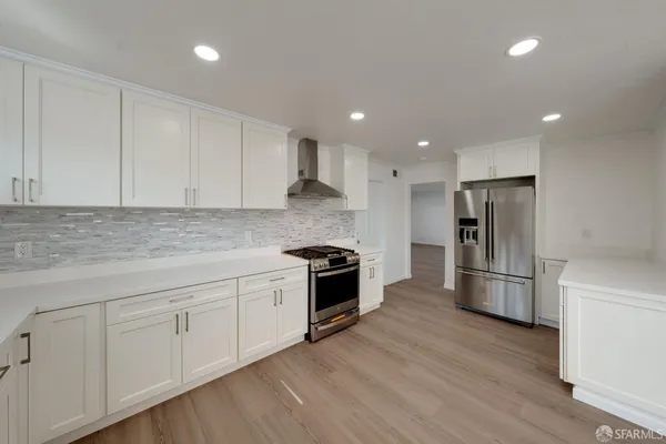 a view of a kitchen with wooden floor and windows