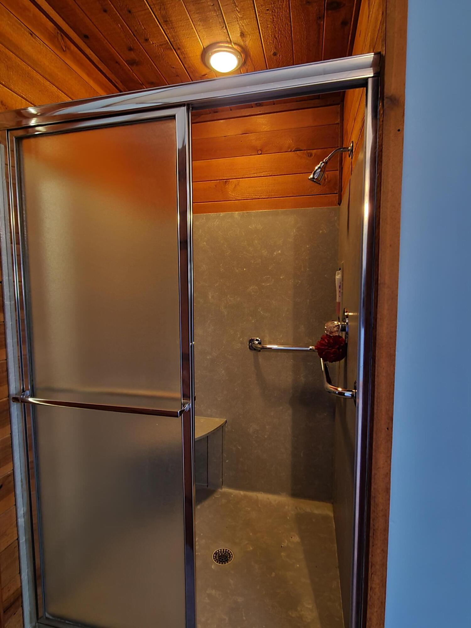 1066 Bay Grove Road Freeport, FL 32439 - Photo 54 of 85 a bathroom with a glass shower door