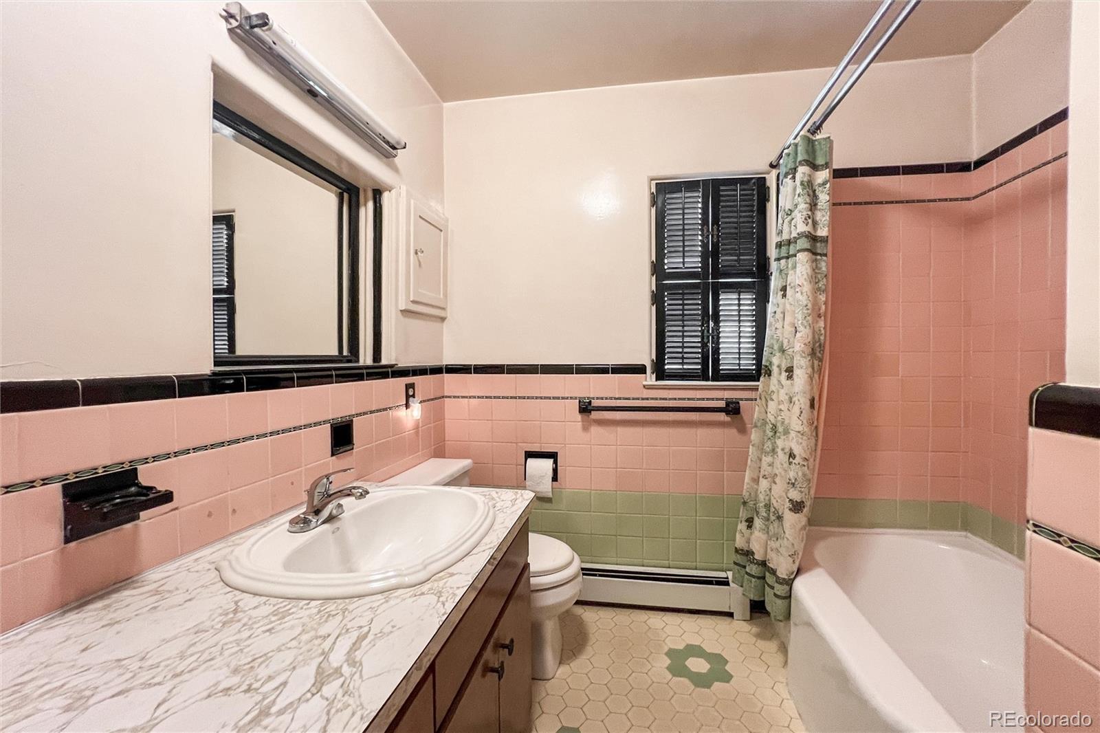3345 Jay Street Wheat Ridge, CO 80033 - Photo 22 of 40 a bathroom with a tub sink and mirror