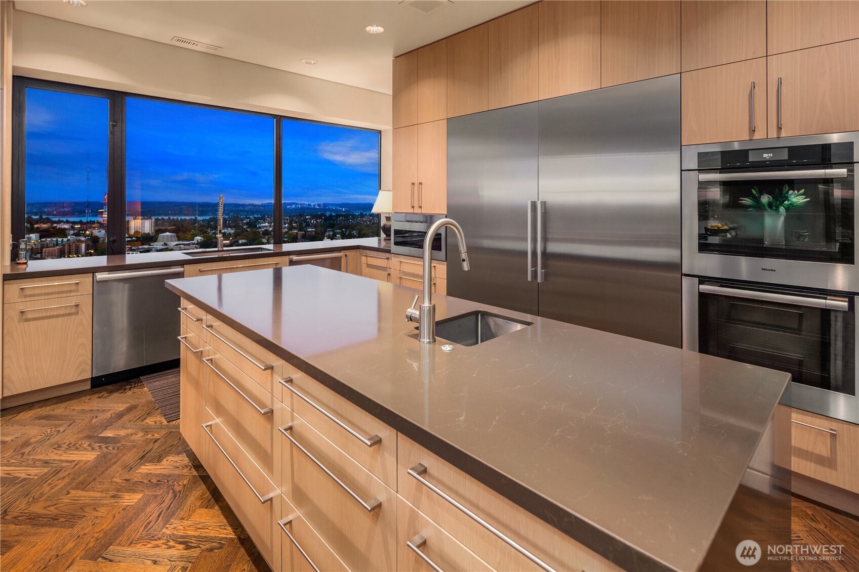 1301 Spring Street, Unit PH32 Seattle, WA 98104 - Photo 20 of 40 a kitchen with stainless steel appliances granite countertop a sink a stove and a refrigerator