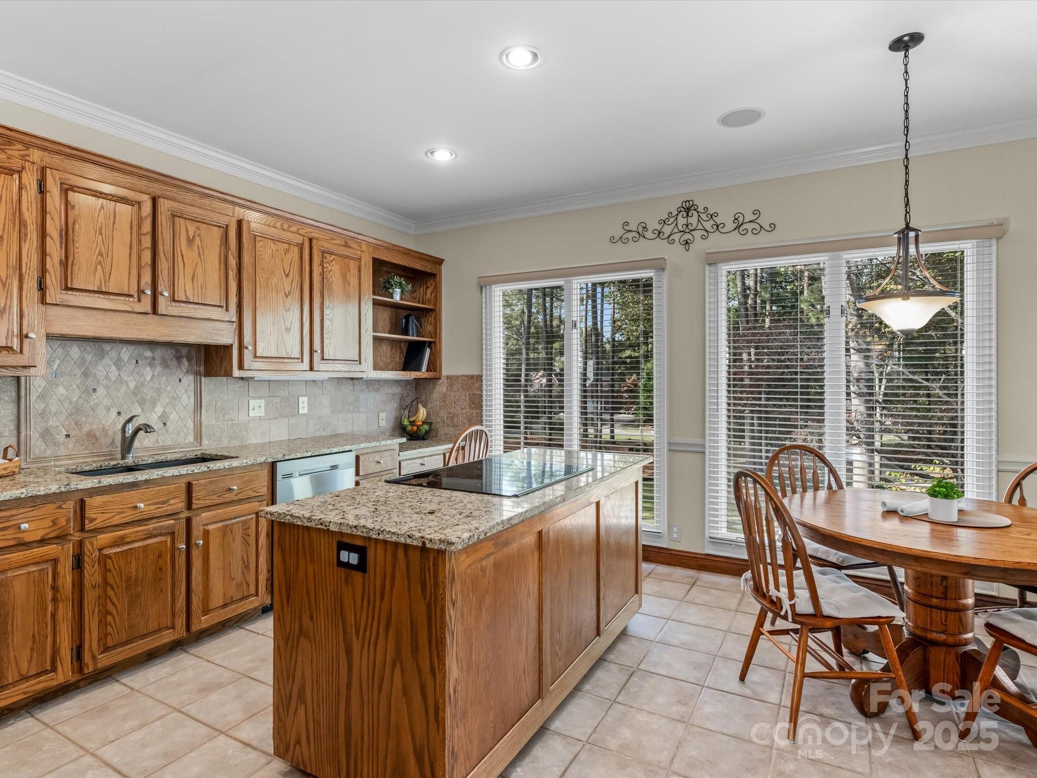 806 Lake Mist Drive Stanley, NC 28164 - Photo 21 of 47 a kitchen with a sink stove and chairs