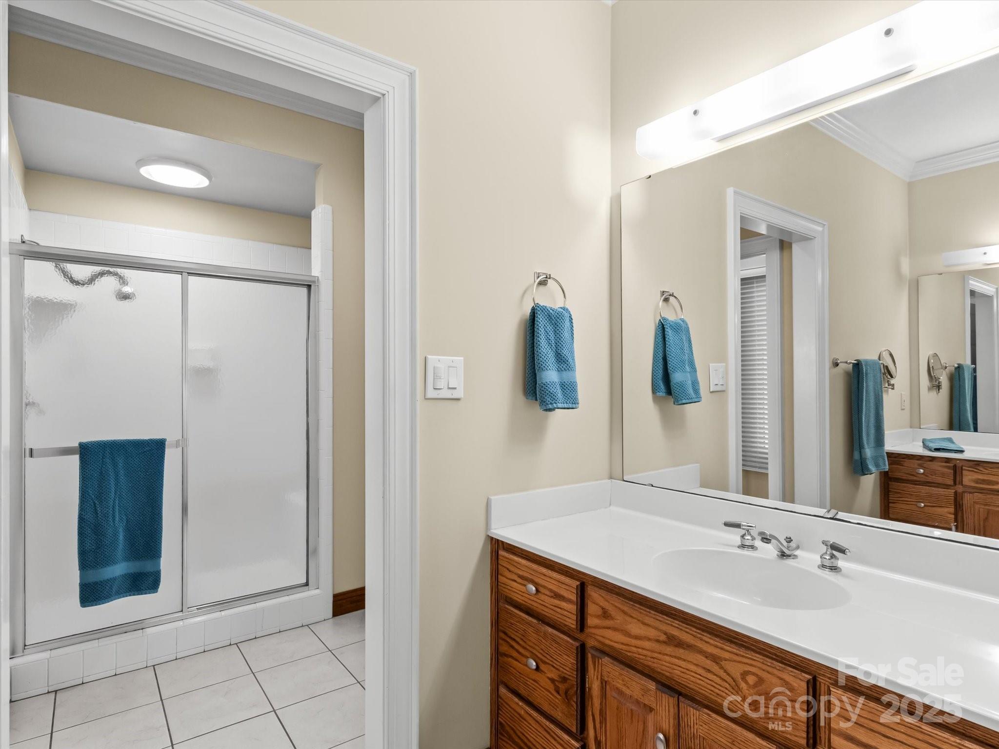 806 Lake Mist Drive Stanley, NC 28164 - Photo 29 of 47 a bathroom with a granite countertop sink mirror and shower