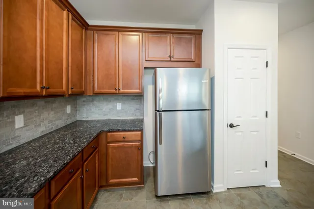 a kitchen with stainless steel appliances granite countertop a stove a sink dishwasher and cabinets with wooden floor