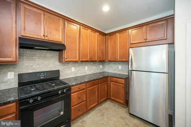 a view of a kitchen with a sink and a refrigerator