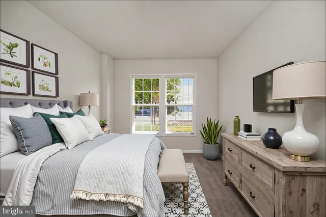 a living room with furniture flowerpot and wooden floor