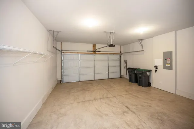 a front view of a house with a yard and potted plants