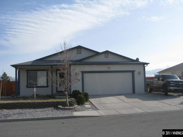 a front view of a house with garage