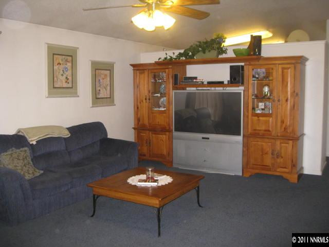 17780 Fairfax Court Reno, NV 89508 - Photo 5 of 13 a living room with furniture a flat screen tv and a table