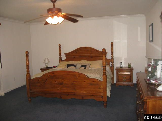 17780 Fairfax Court Reno, NV 89508 - Photo 6 of 13 a bedroom with a bed and a chandelier