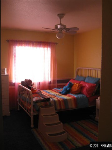 17780 Fairfax Court Reno, NV 89508 - Photo 8 of 13 a bed sitting in a bedroom next to a window