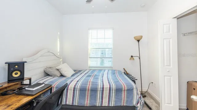 a bedroom with a bed and a window