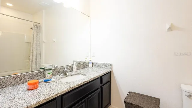 a white bath tub sitting next to a white toilet