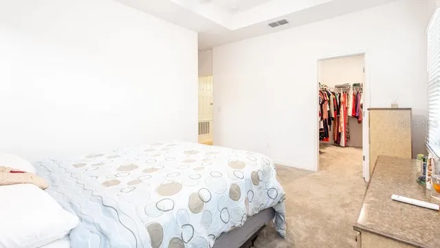 a bathroom with a granite countertop sink two mirror and shower