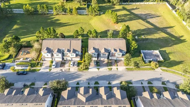 an aerial view of residential houses with outdoor space