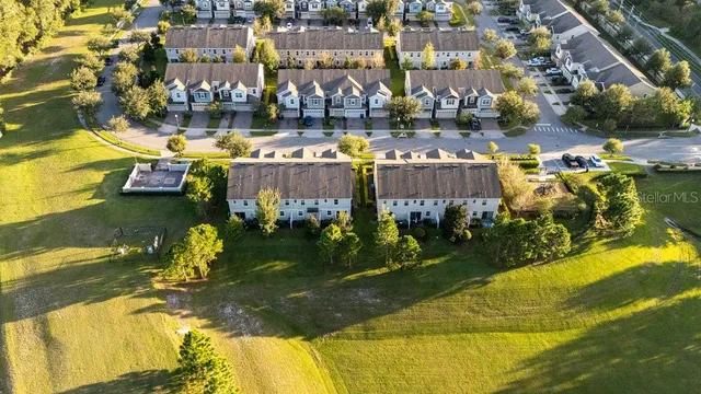 an aerial view of residential houses with outdoor space