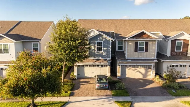 a view of a house with a big yard and potted plants