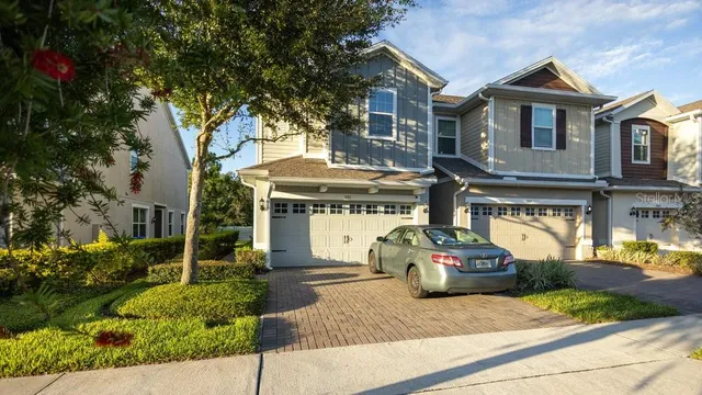 a car parked in front of a brick house