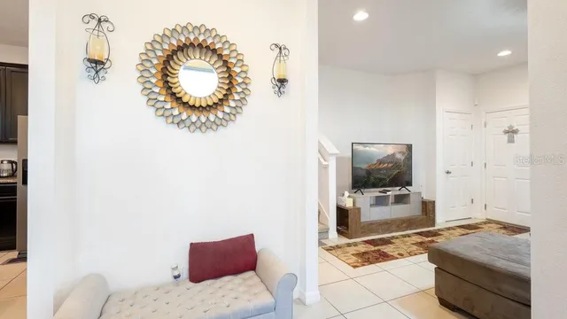 a living room with furniture a fireplace and a chandelier