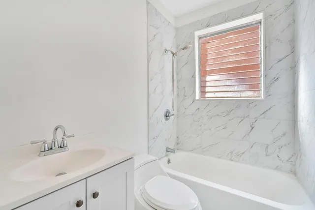 a bathroom with a sink toilet and bathtub