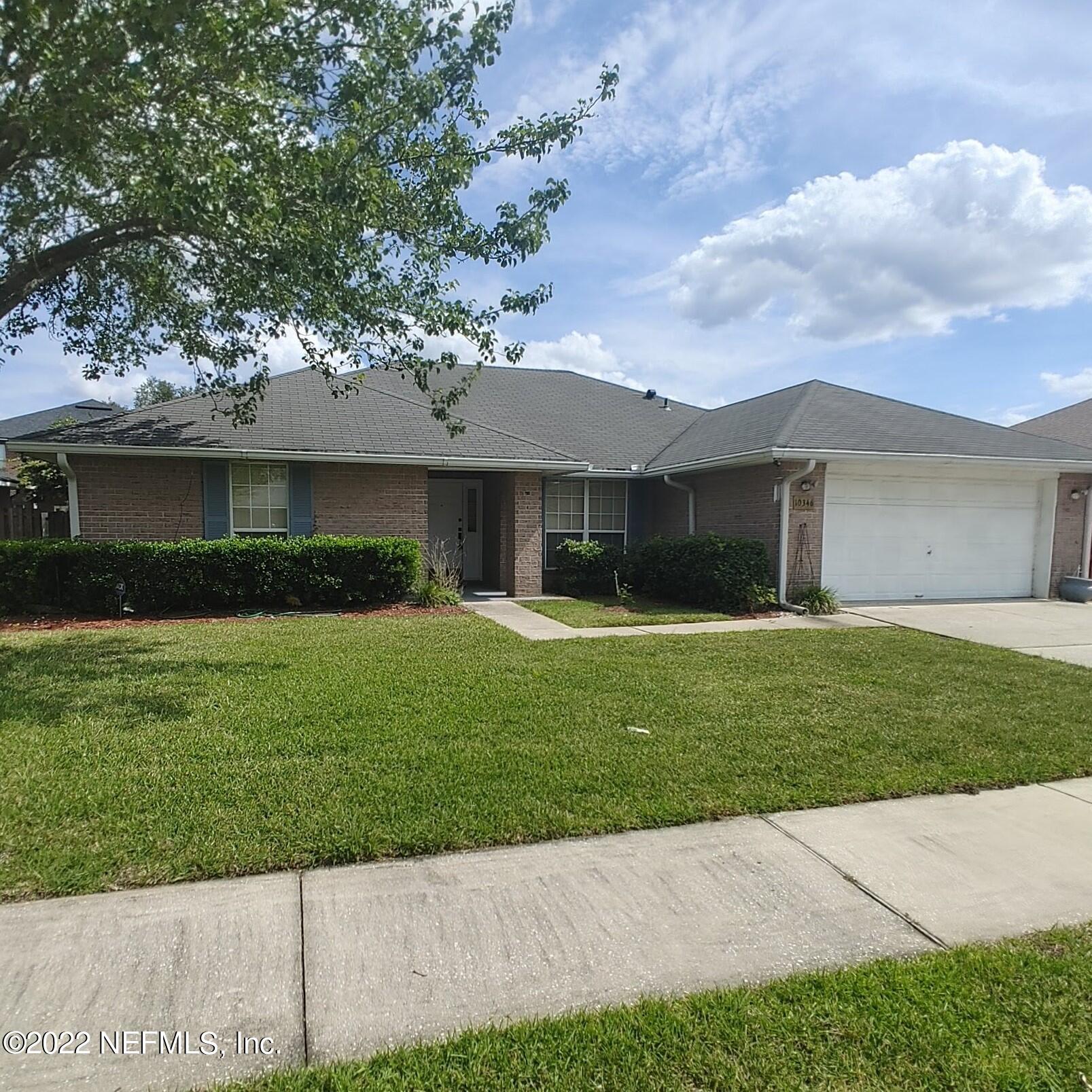 10346 Clayton Mill Road Jacksonville, FL 32221 - Photo 1 of 19 a front view of a house with a garden