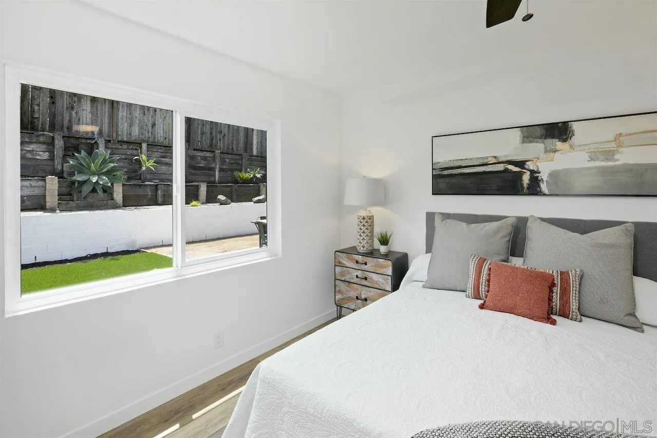 725 Cathy Lane Encinitas, CA 92007 - Photo 13 of 31 a bedroom with a bed and large window