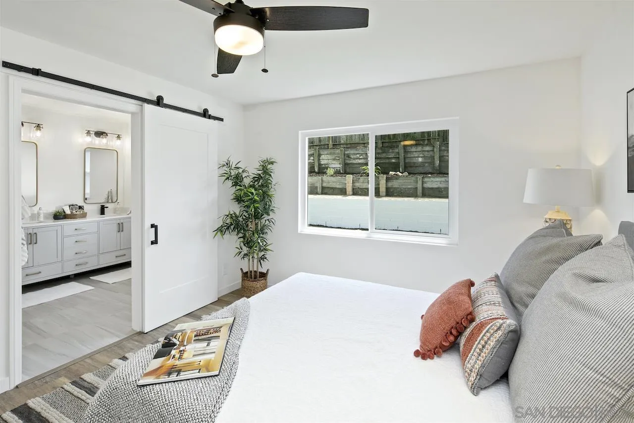 725 Cathy Lane Encinitas, CA 92007 - Photo 16 of 31 a bedroom with a bed and a large window