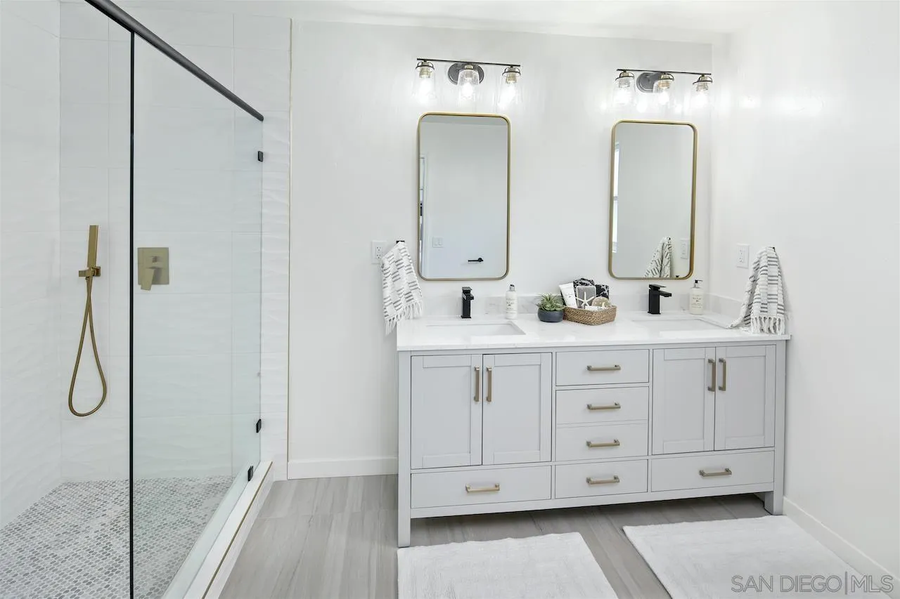 725 Cathy Lane Encinitas, CA 92007 - Photo 17 of 31 a bathroom with double vanity sinks double vanity tub and shower