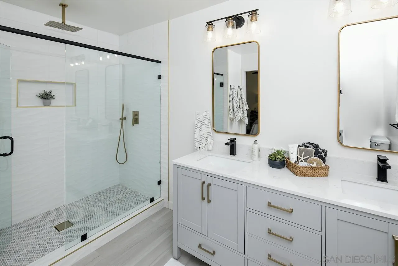 725 Cathy Lane Encinitas, CA 92007 - Photo 18 of 31 a bathroom with a granite countertop sink a mirror a vanity and shower