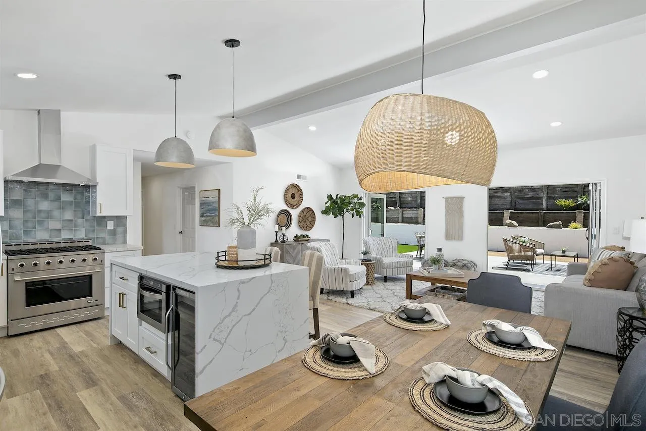 725 Cathy Lane Encinitas, CA 92007 - Photo 3 of 31 a open kitchen with stainless steel appliances granite countertop a stove a kitchen island a dining table and chairs with wooden floor