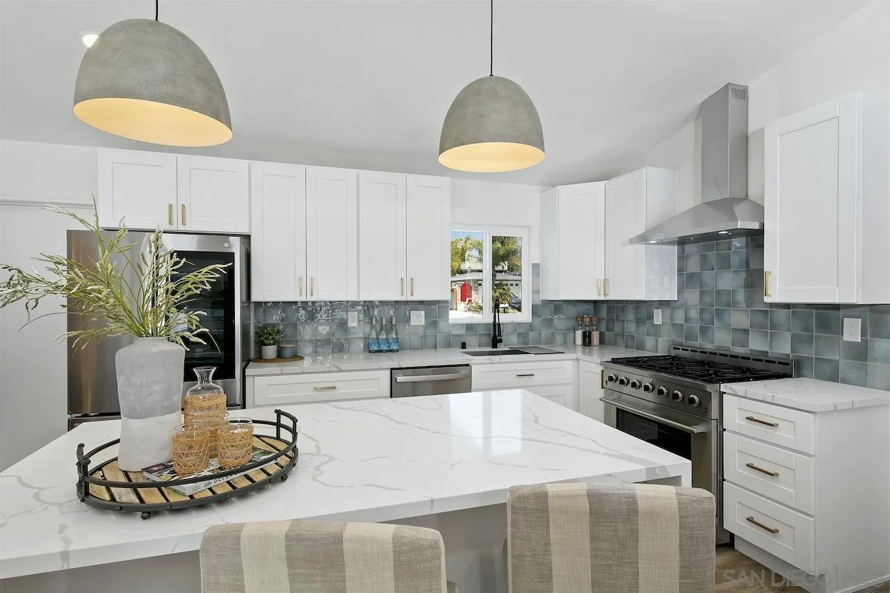 725 Cathy Lane Encinitas, CA 92007 - Photo 4 of 31 a kitchen with stainless steel appliances granite countertop a sink a stove and a wooden floors