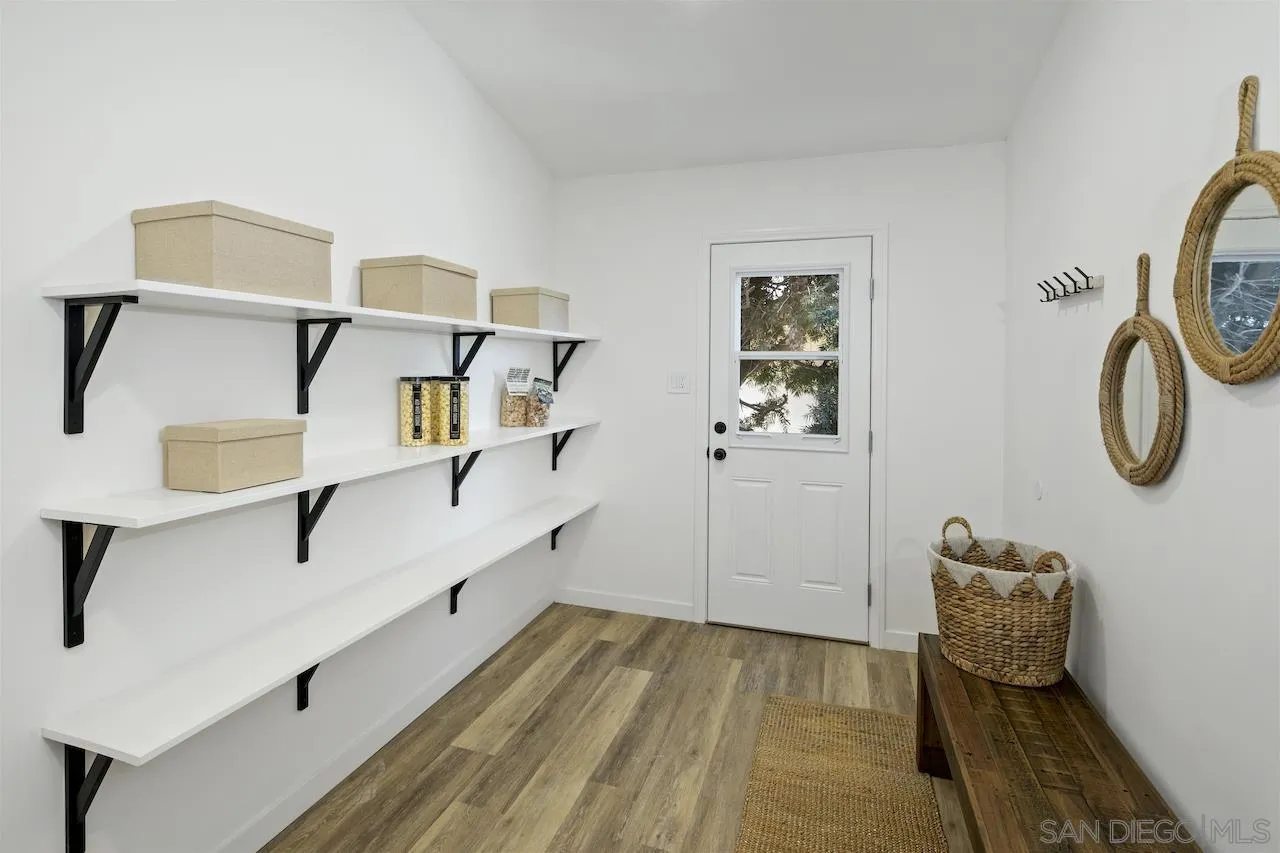 725 Cathy Lane Encinitas, CA 92007 - Photo 5 of 31 a hallway with table and flowerpot