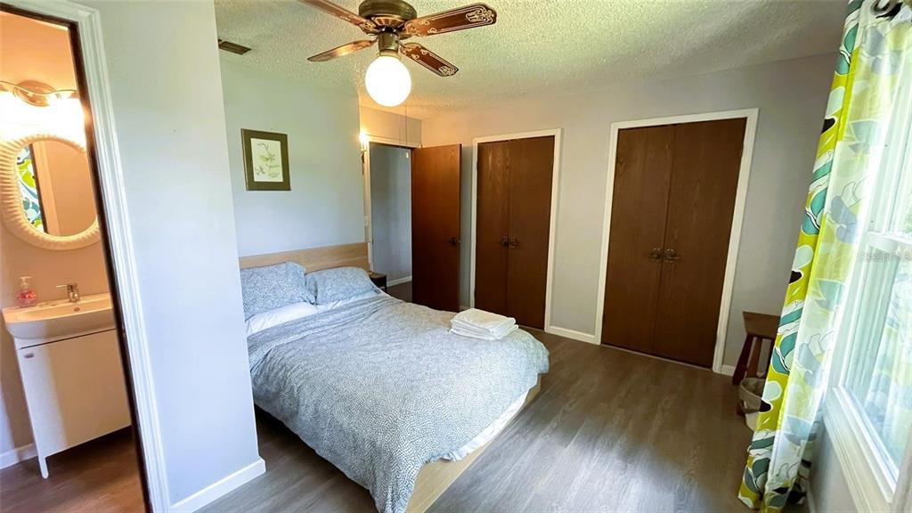 151 Twin Lakes Road Hawthorne, FL 32640 - Photo 11 of 28 a bedroom with a bed and a mirror