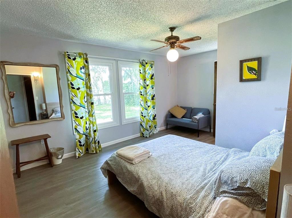 151 Twin Lakes Road Hawthorne, FL 32640 - Photo 12 of 28 a bedroom with a bed and a chandelier