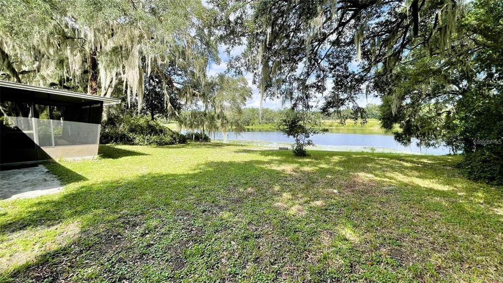 151 Twin Lakes Road Hawthorne, FL 32640 - Photo 18 of 28 a view of yard with swimming pool and trees