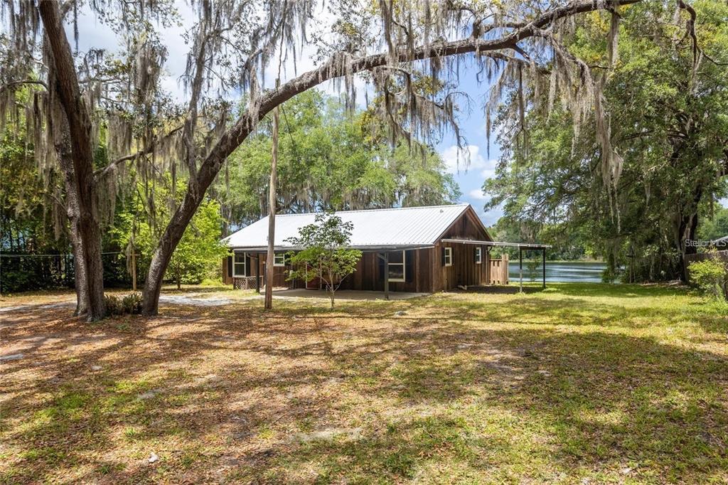 151 Twin Lakes Road Hawthorne, FL 32640 - Photo 22 of 28 a front view of a house with a yard and trees