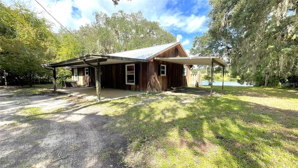 151 Twin Lakes Road Hawthorne, FL 32640 - Photo 23 of 28 a view of a house with a yard and large tree
