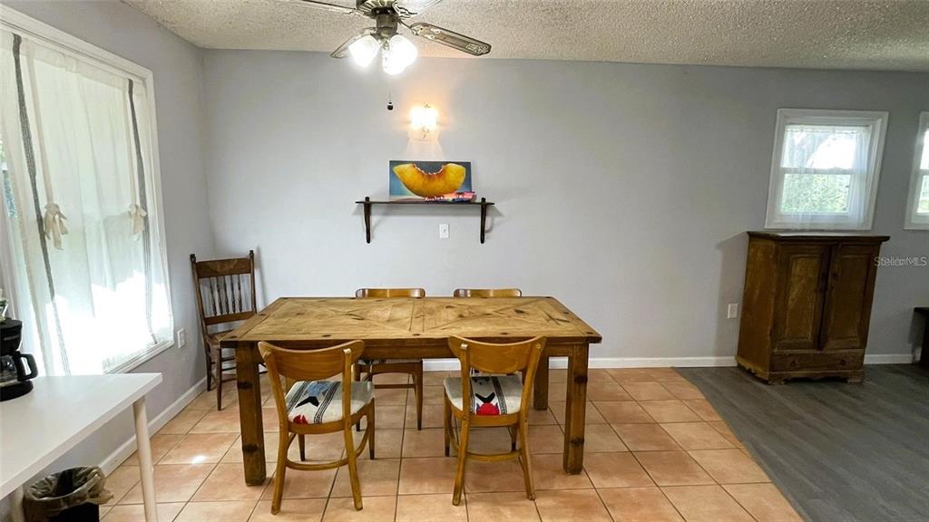 151 Twin Lakes Road Hawthorne, FL 32640 - Photo 8 of 28 a view of a dining room with furniture and wooden floor