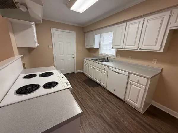 a kitchen with white cabinets and white appliances