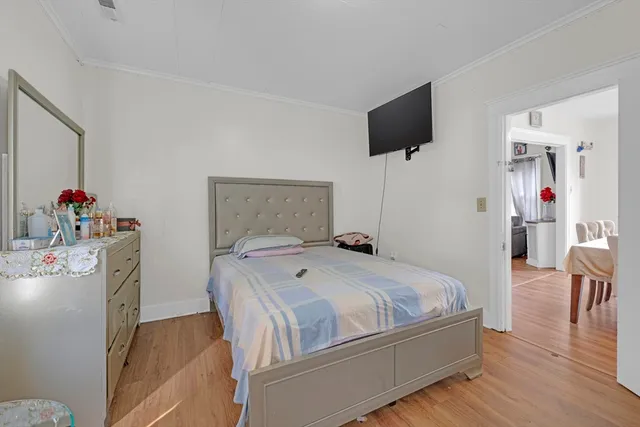 a bedroom with a bed and flat screen tv