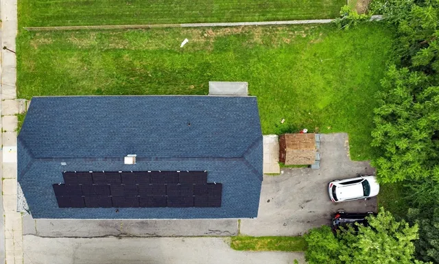 an aerial view of a house with a yard