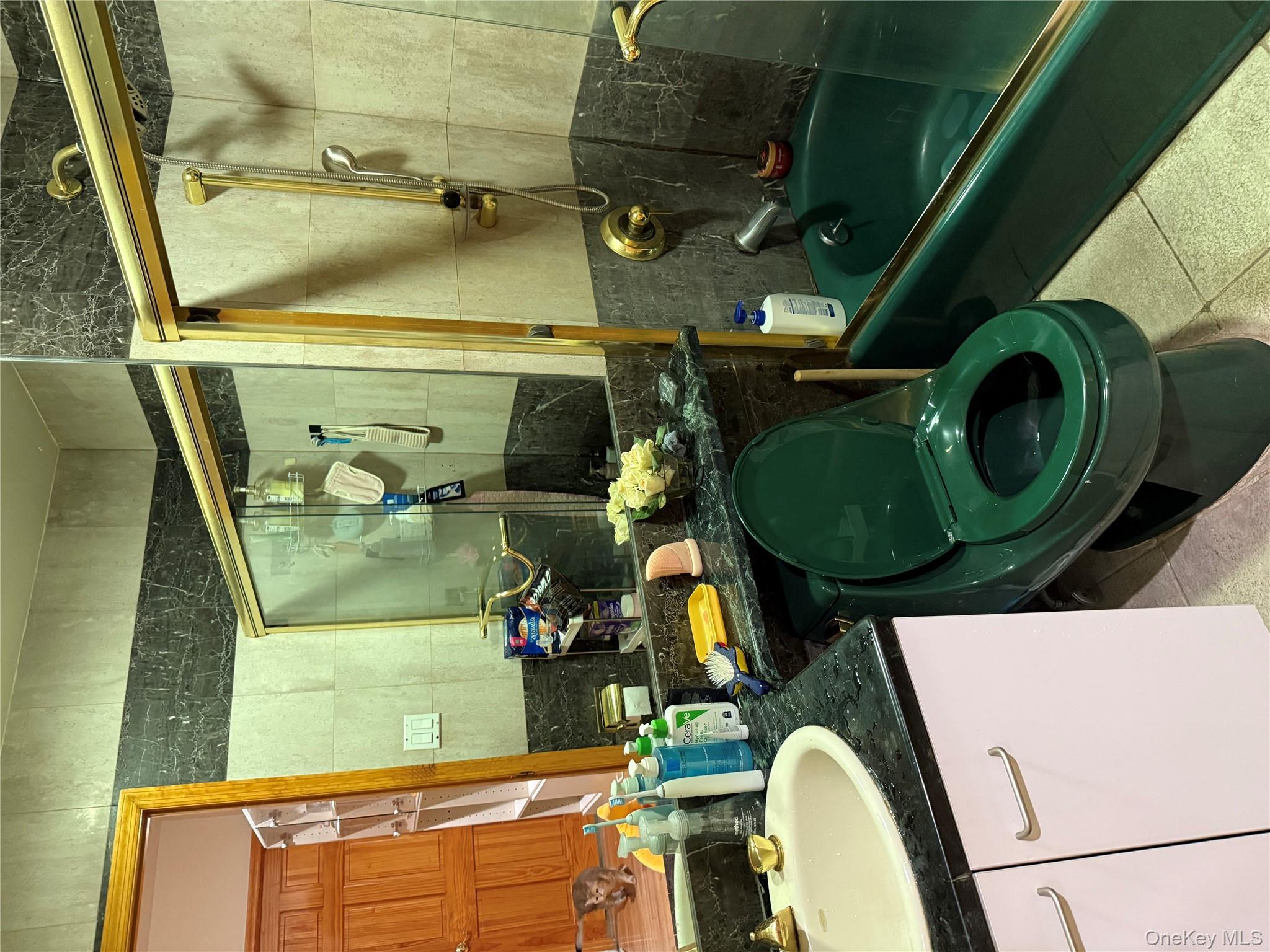 42-31 Colden Street, Unit F7A Queens, NY 11355 - Photo 12 of 18 a bathroom with a sink toilet and shower