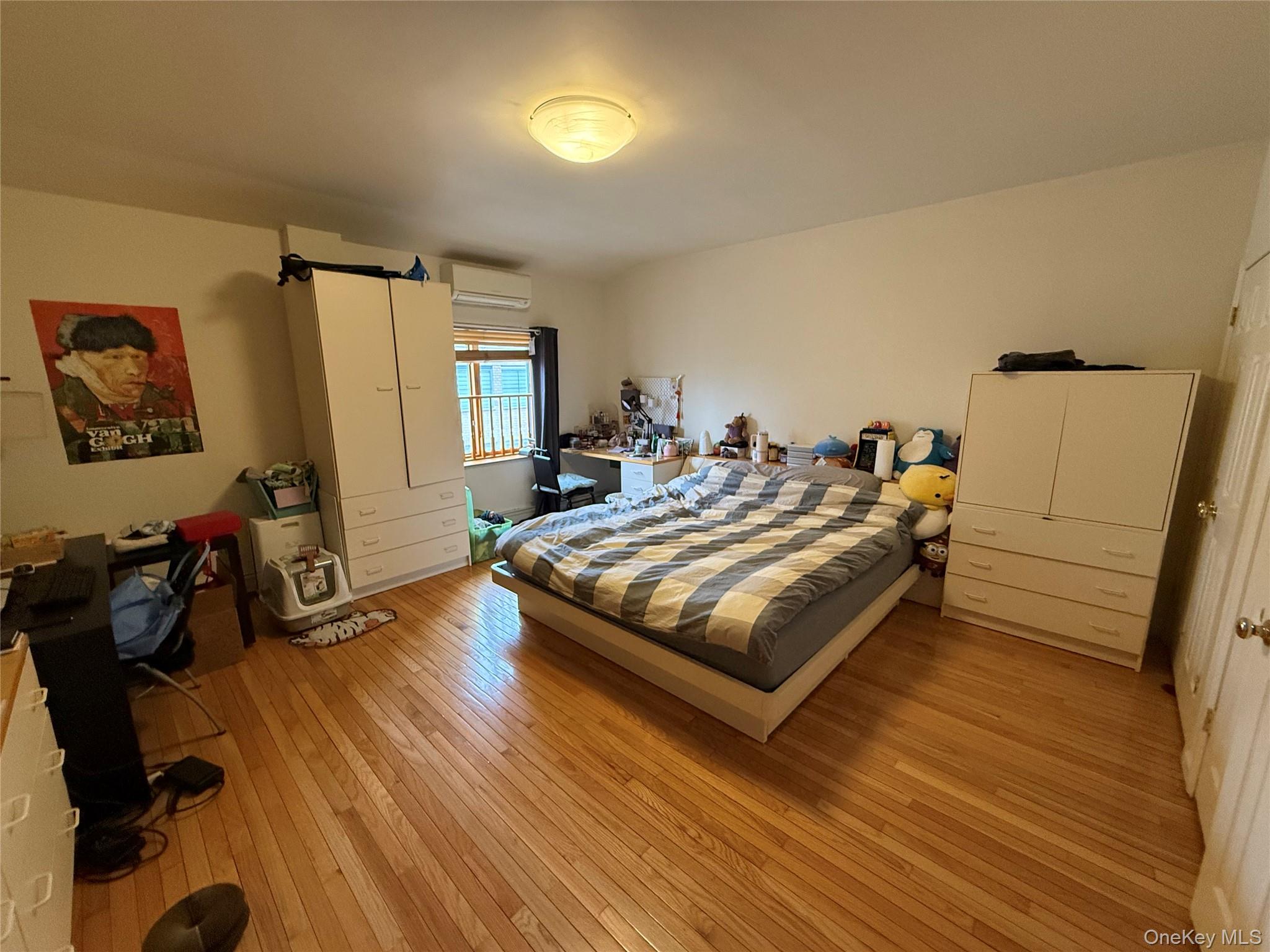 42-31 Colden Street, Unit F7A Queens, NY 11355 - Photo 14 of 18 a bedroom with a bed and wooden floor