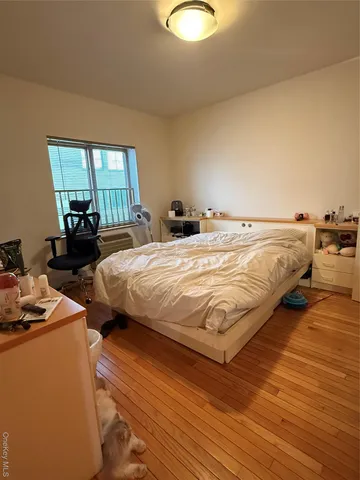 a bedroom with bed and window