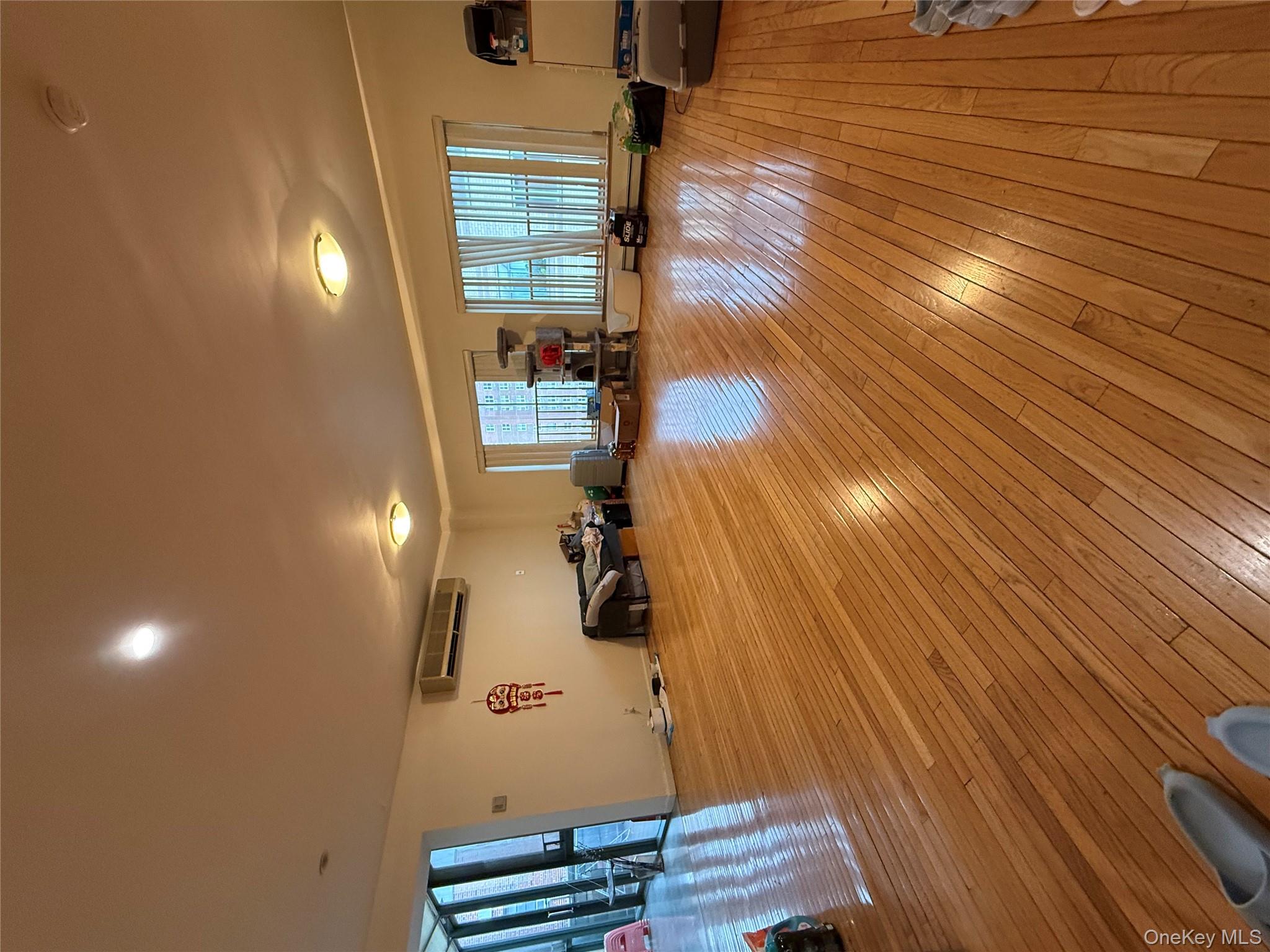 42-31 Colden Street, Unit F7A Queens, NY 11355 - Photo 3 of 18 a view of a room with wooden floor and window