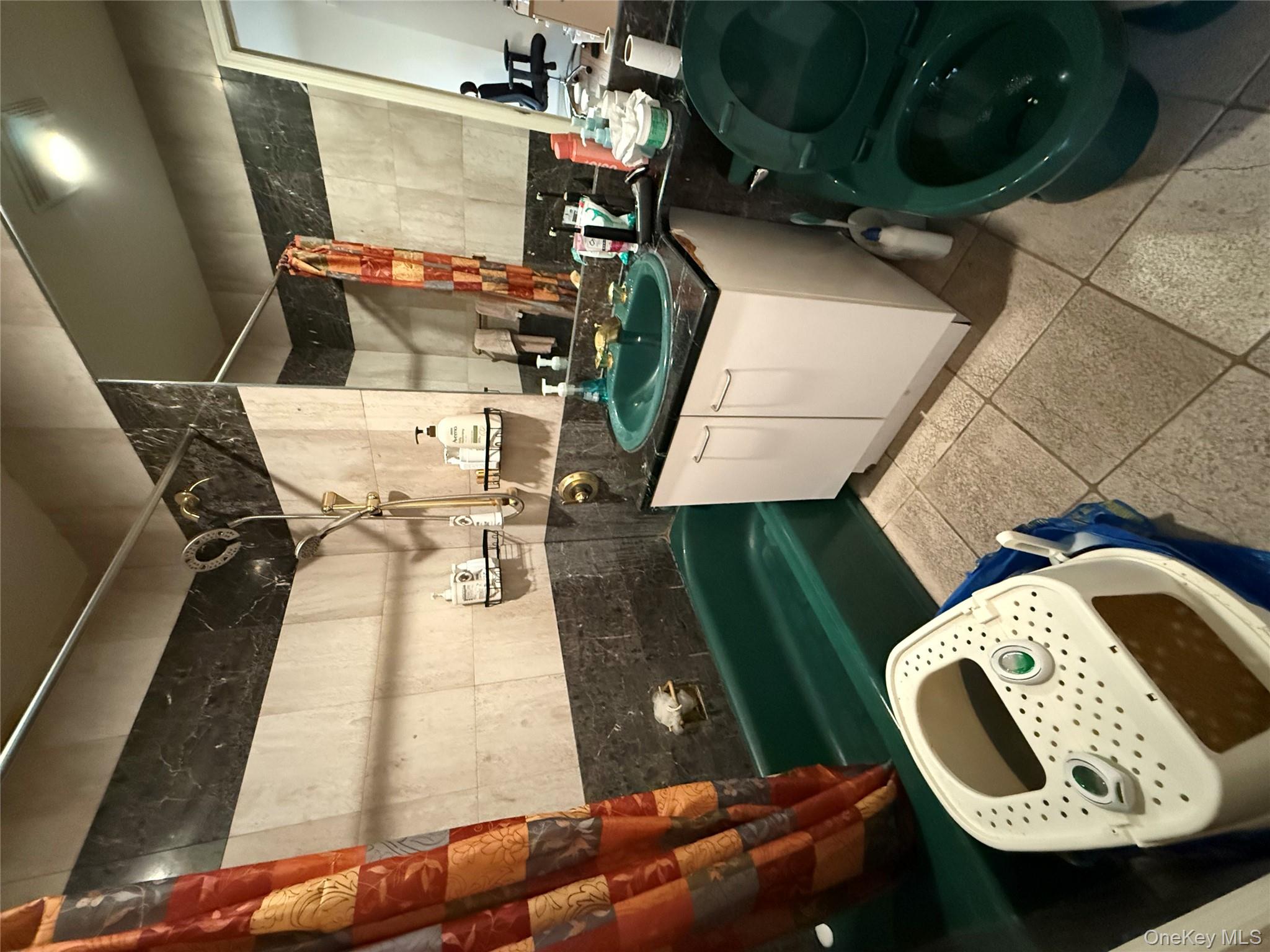 42-31 Colden Street, Unit F7A Queens, NY 11355 - Photo 7 of 18 a bathroom with a sink mirror and vanity